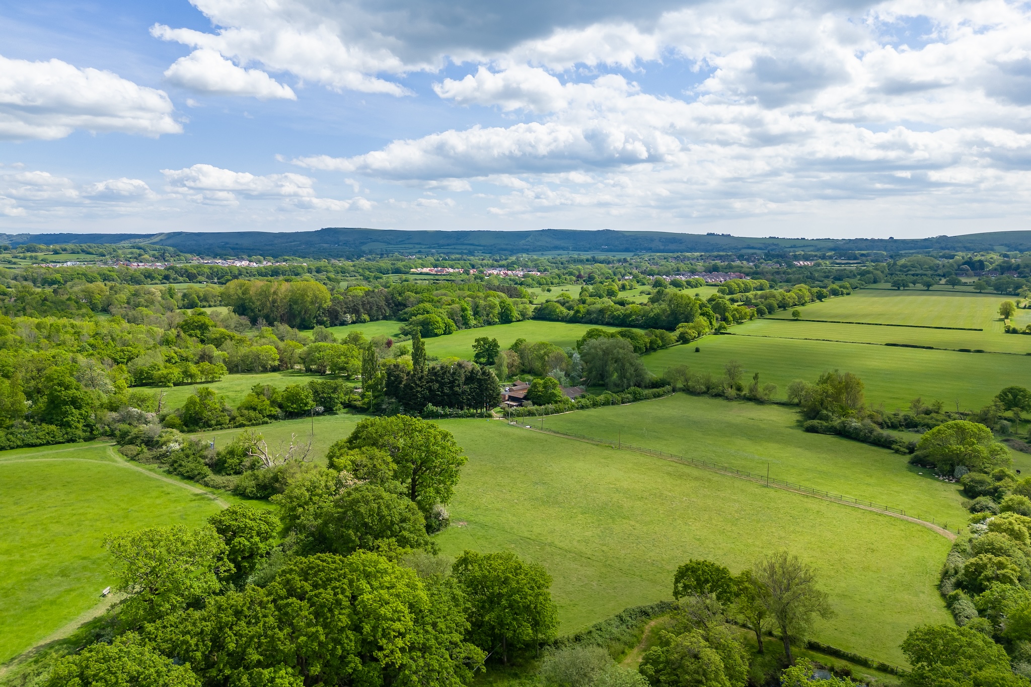 Aerial view of the cottage set within South Downs woodland and countryside